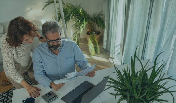 Senior couple home going over paperwork